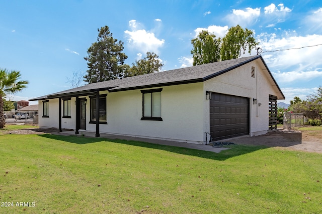 exterior space featuring a garage and a front yard