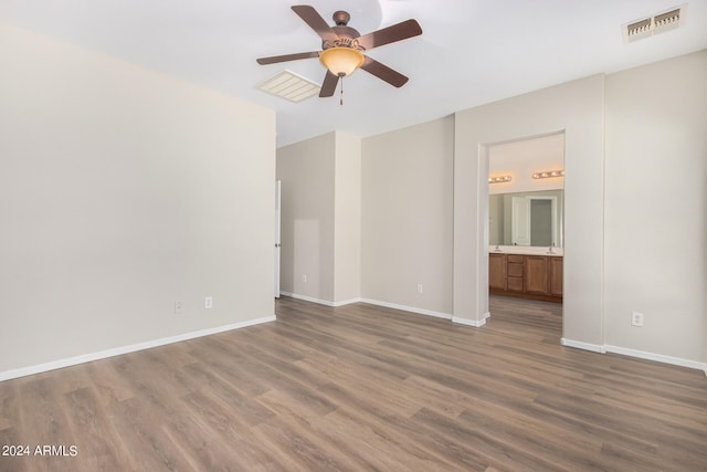 unfurnished room featuring ceiling fan and dark wood-type flooring