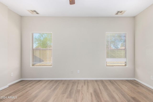 10722 W Jefferson St, Avondale, AZ 85323 - empty room featuring healthy amount of natural light, light wood-type flooring, and baseboards