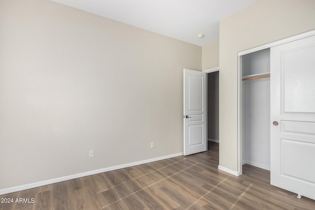10722 W Jefferson St, Avondale, AZ 85323 - unfurnished bedroom with wood finished floors, a closet, and baseboards