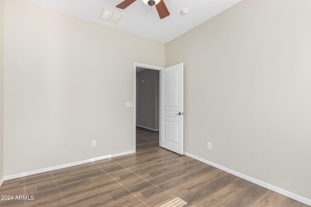 unfurnished room with ceiling fan and dark hardwood / wood-style flooring