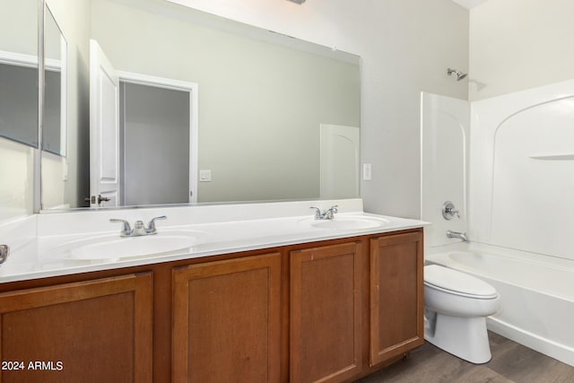 full bathroom with tub / shower combination, vanity, toilet, and hardwood / wood-style flooring