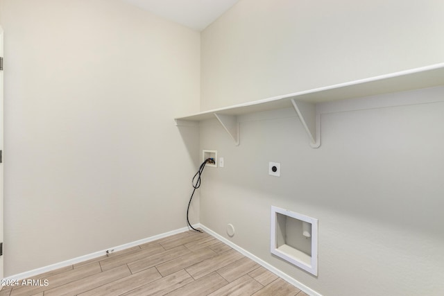 laundry area featuring light wood-type flooring, hookup for a gas dryer, electric dryer hookup, and washer hookup