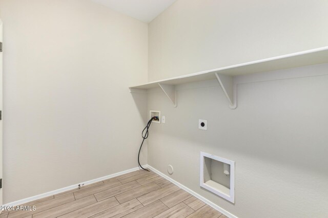 10722 W Jefferson St, Avondale, AZ 85323 - washroom with hookup for a washing machine, hookup for a gas dryer, light wood finished floors, hookup for an electric dryer, and baseboards