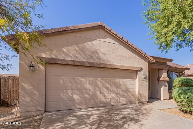 10722 W Jefferson St, Avondale, AZ 85323 - view of front of property featuring stucco siding, an attached garage, a tile roof, and concrete driveway