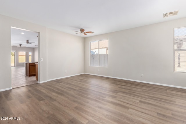 unfurnished room featuring ceiling fan and hardwood / wood-style floors