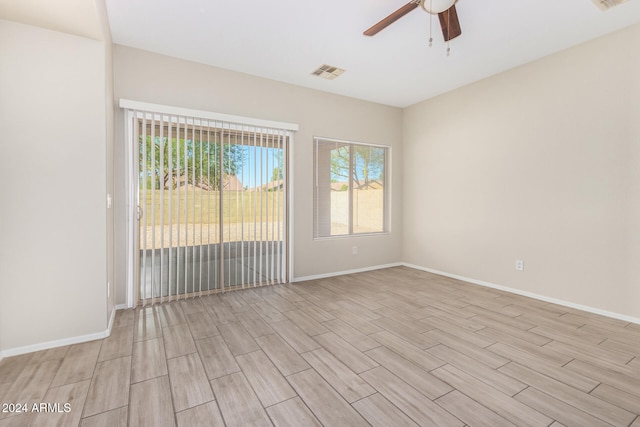 spare room featuring light hardwood / wood-style flooring and ceiling fan