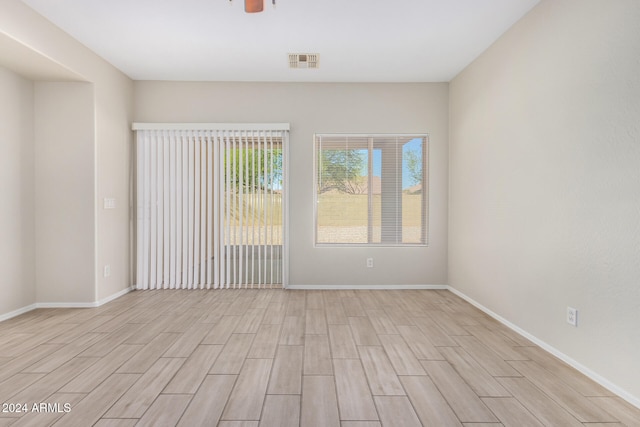 empty room with light hardwood / wood-style flooring and ceiling fan