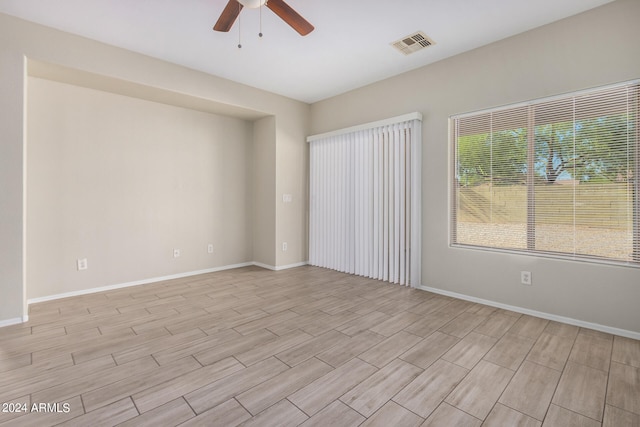 unfurnished room with light hardwood / wood-style flooring and ceiling fan