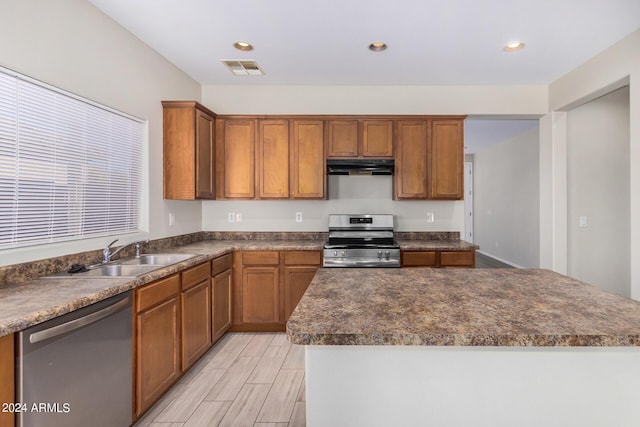 10722 W Jefferson St, Avondale, AZ 85323 - kitchen featuring appliances with stainless steel finishes, under cabinet range hood, a sink, dark countertops, and recessed lighting