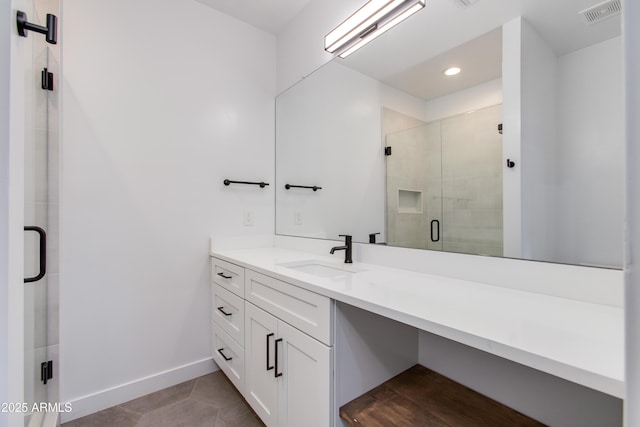 bathroom featuring a stall shower, baseboards, vanity, recessed lighting, and tile patterned floors