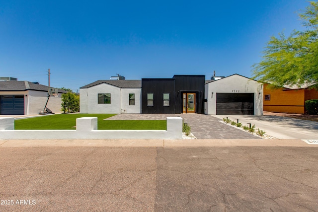 view of front of property featuring a front lawn, driveway, and an attached garage