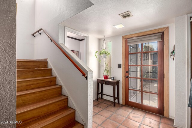 kitchen featuring dark brown cabinetry, stainless steel appliances, and light hardwood / wood-style flooring