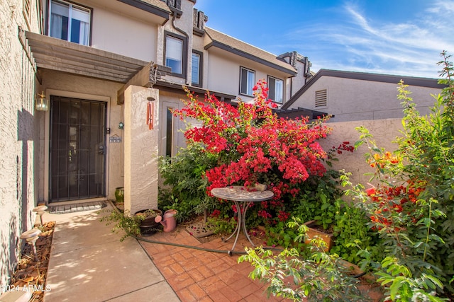 property entrance featuring a patio area