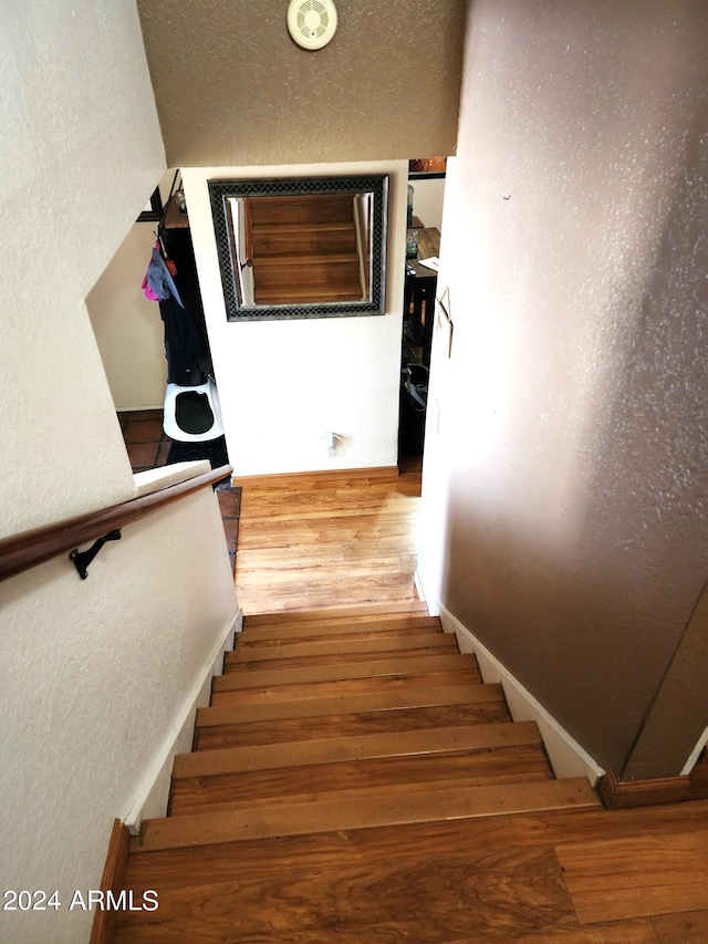 stairway featuring hardwood / wood-style floors