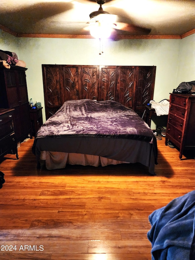 bedroom with ceiling fan, light hardwood / wood-style flooring, and ornamental molding