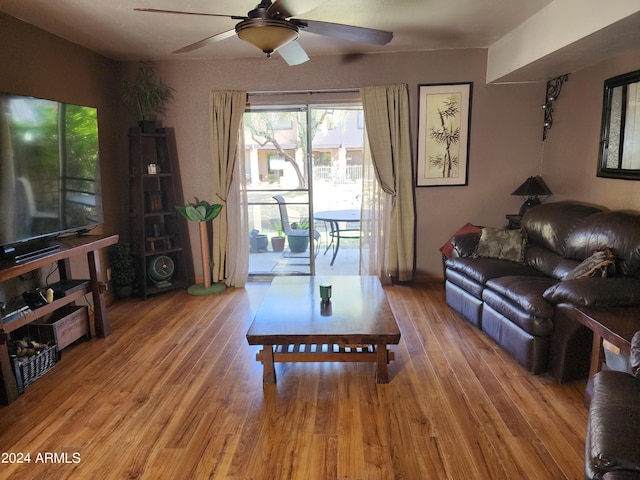 living room featuring hardwood / wood-style flooring and ceiling fan