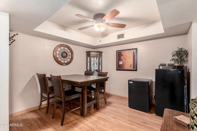 kitchen with dishwasher, dark brown cabinets, sink, and hardwood / wood-style flooring