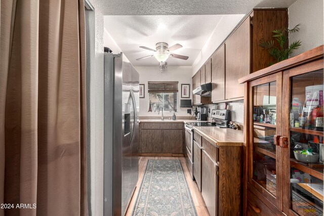 kitchen with electric range, range hood, and hardwood / wood-style floors