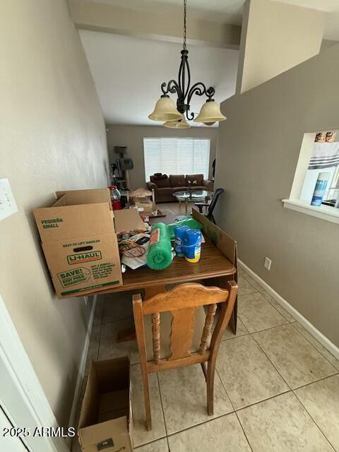 dining space featuring beam ceiling, tile patterned floors, baseboards, and a chandelier