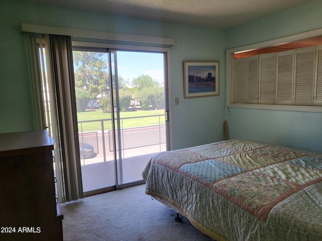 bedroom featuring a textured ceiling, access to exterior, and carpet floors