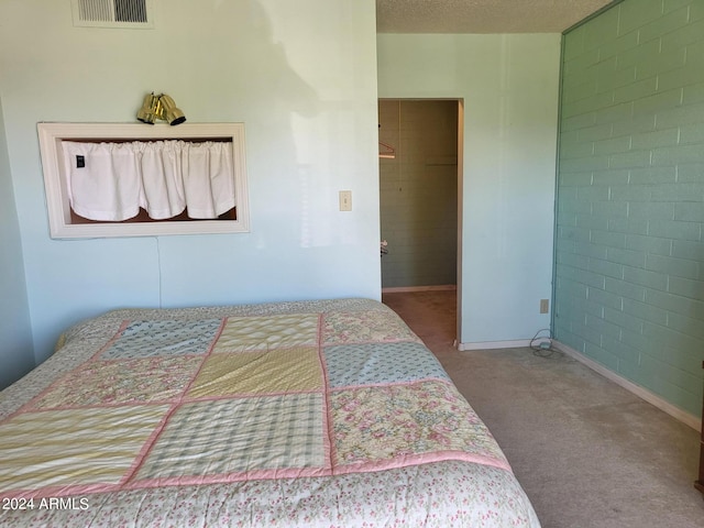 bedroom with carpet floors and a textured ceiling