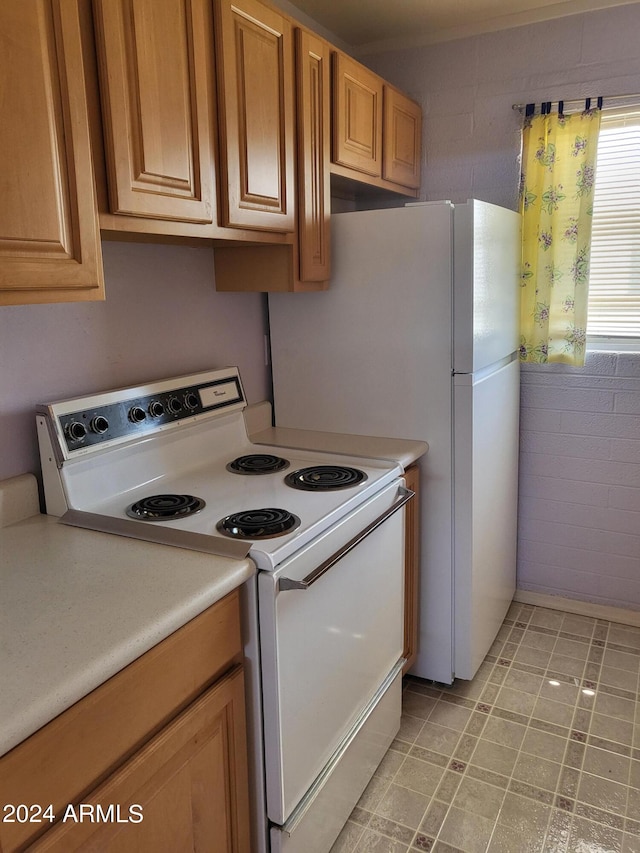 kitchen featuring white range with electric cooktop and light tile patterned flooring