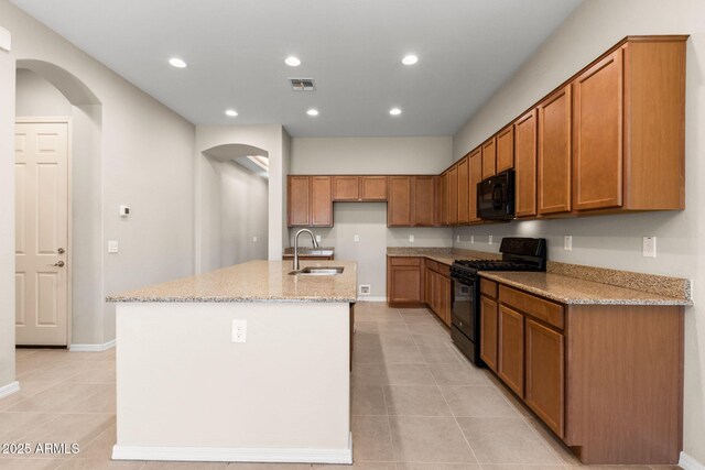 3072 E Appaloosa Rd, Gilbert, AZ 85296 - kitchen featuring visible vents, a sink, arched walkways, light tile patterned flooring, and black appliances