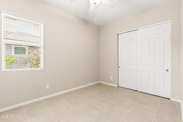 3072 E Appaloosa Rd, Gilbert, AZ 85296 - unfurnished bedroom with a ceiling fan, baseboards, a closet, and light tile patterned flooring