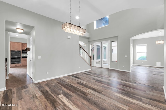 18544 E Caledonia Dr, Queen Creek, AZ 85142 - interior space featuring dark wood finished floors, stairs, baseboards, and arched walkways