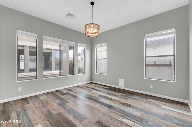 18544 E Caledonia Dr, Queen Creek, AZ 85142 - spare room featuring baseboards, wood finished floors, visible vents, and a chandelier