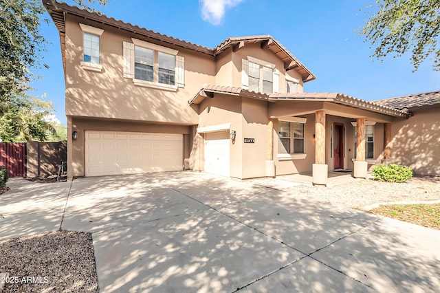 18544 E Caledonia Dr, Queen Creek, AZ 85142 - mediterranean / spanish-style home with stucco siding, a tile roof, fence, concrete driveway, and an attached garage