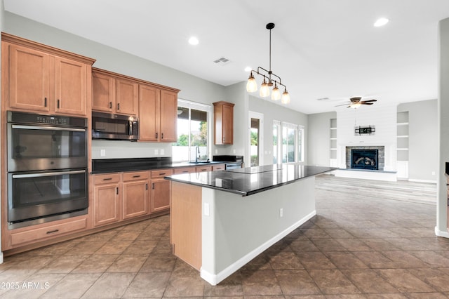 18544 E Caledonia Dr, Queen Creek, AZ 85142 - kitchen with built in shelves, visible vents, ceiling fan, stainless steel appliances, and dark countertops