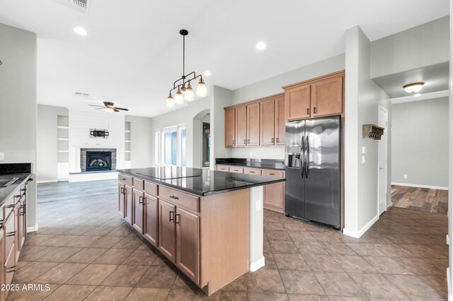 18544 E Caledonia Dr, Queen Creek, AZ 85142 - kitchen featuring built in features, a ceiling fan, arched walkways, stainless steel refrigerator with ice dispenser, and open floor plan