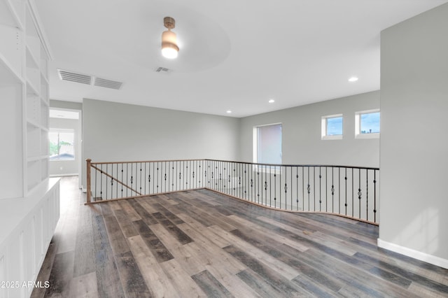 18544 E Caledonia Dr, Queen Creek, AZ 85142 - unfurnished room featuring recessed lighting, wood finished floors, visible vents, and baseboards