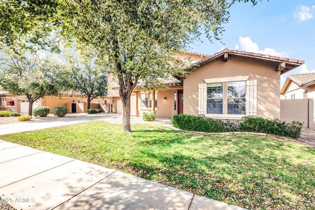 18544 E Caledonia Dr, Queen Creek, AZ 85142 - view of front of property with stucco siding, a tile roof, fence, concrete driveway, and a front yard