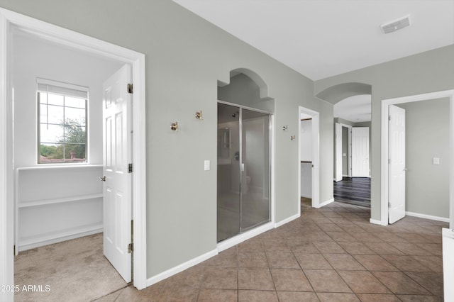 18544 E Caledonia Dr, Queen Creek, AZ 85142 - interior space featuring a shower stall, baseboards, visible vents, and tile patterned floors