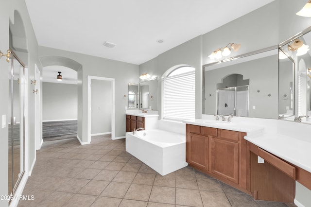 18544 E Caledonia Dr, Queen Creek, AZ 85142 - bathroom with a garden tub, a stall shower, tile patterned floors, a ceiling fan, and a sink