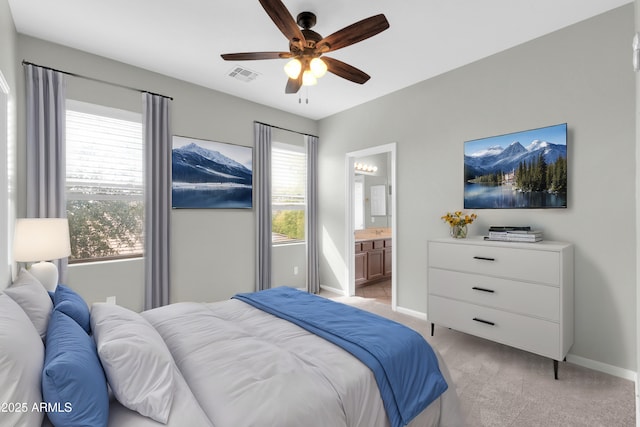 18544 E Caledonia Dr, Queen Creek, AZ 85142 - bedroom featuring visible vents, light colored carpet, ensuite bathroom, and baseboards