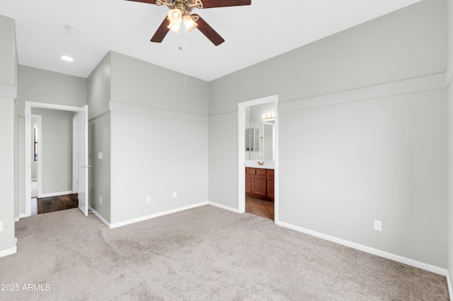 18544 E Caledonia Dr, Queen Creek, AZ 85142 - unfurnished bedroom featuring connected bathroom, baseboards, a ceiling fan, and carpet flooring