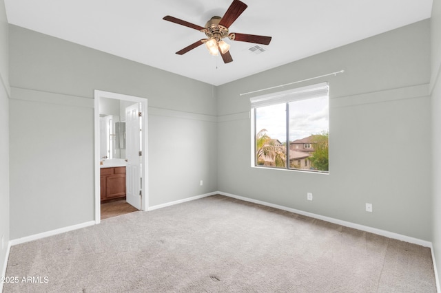 18544 E Caledonia Dr, Queen Creek, AZ 85142 - unfurnished bedroom with visible vents, connected bathroom, baseboards, carpet, and ceiling fan