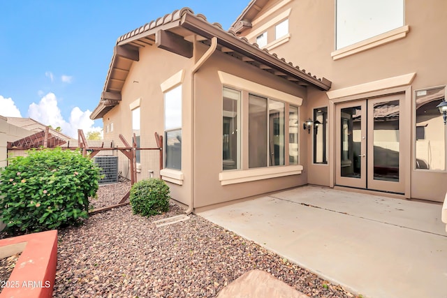 18544 E Caledonia Dr, Queen Creek, AZ 85142 - rear view of property featuring stucco siding, fence, central AC unit, and a patio area