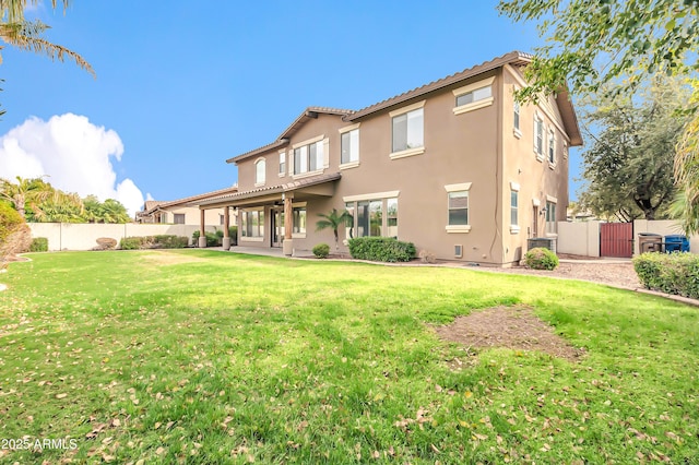 18544 E Caledonia Dr, Queen Creek, AZ 85142 - back of house with a patio area, a fenced backyard, a lawn, and stucco siding