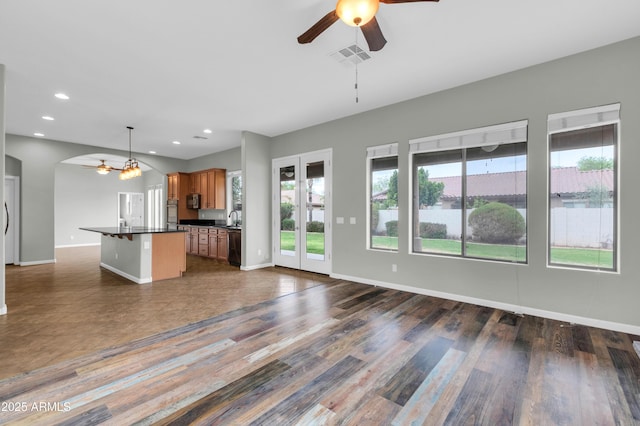 18544 E Caledonia Dr, Queen Creek, AZ 85142 - kitchen with visible vents, dark countertops, open floor plan, and a ceiling fan