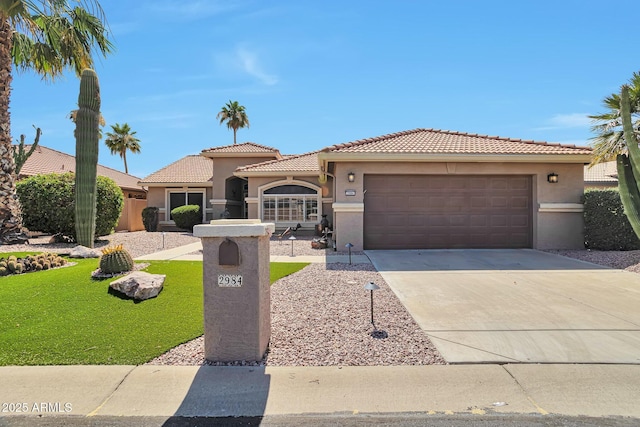 2984 N 152nd Dr, Goodyear, AZ 85395 - mediterranean / spanish house with stucco siding, a tile roof, driveway, and a front lawn