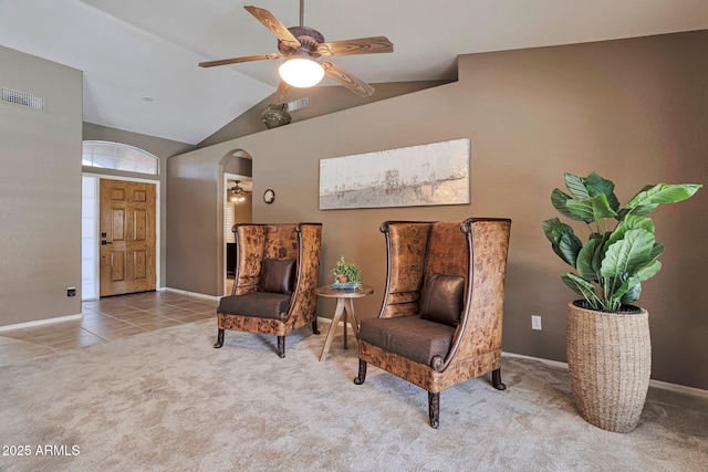 2984 N 152nd Dr, Goodyear, AZ 85395 - sitting room featuring a ceiling fan, vaulted ceiling, carpet floors, arched walkways, and tile patterned floors