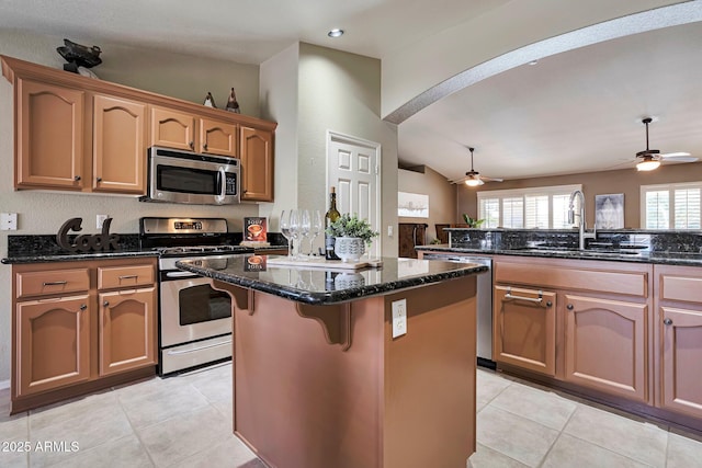 2984 N 152nd Dr, Goodyear, AZ 85395 - kitchen featuring stainless steel appliances, ceiling fan, a kitchen island, arched walkways, and recessed lighting