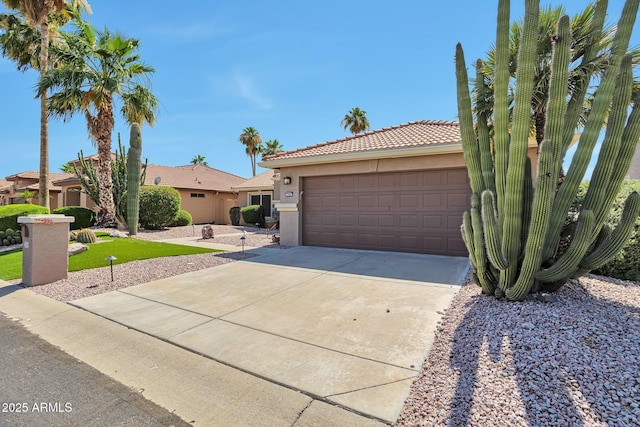 2984 N 152nd Dr, Goodyear, AZ 85395 - view of front of property with a tiled roof, concrete driveway, stucco siding, and a garage