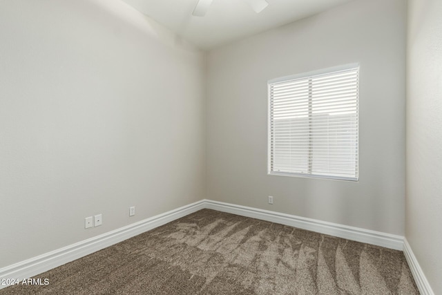 unfurnished room with ceiling fan and carpet floors