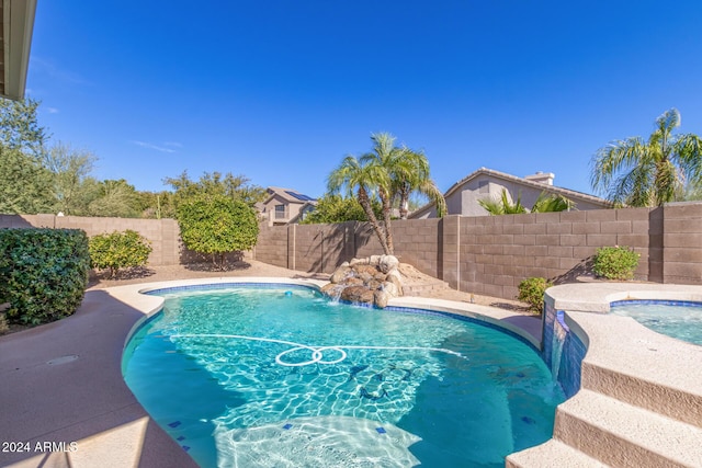 view of pool with pool water feature